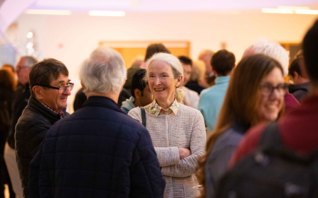 Alumni smiling and mingling at a UCD Physics Reunion.